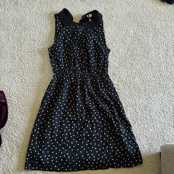 A black polka dot dress with a belt around middle. - Picture 1 of 2